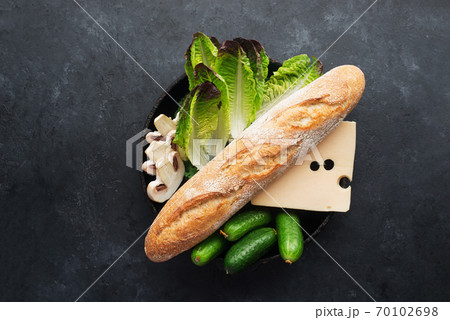Baguette cheese vegetables ingredients for a fresh crispy sandwich for breakfast or a snack for the whole family. Healthy and comfortable food. Top view. Flat lay, 70102698