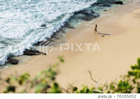 beautiful girl walks along the wild beach 70105052