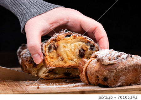 Selective focus. The girl raises a cut piece of homemade raisin pie. 70105343