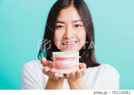 woman smile have dental braces on teeth laughing she holding medical equipment dental model teeth woman smile have dental braces on teeth laughing she holding medical equipment dental model teeth 70110681