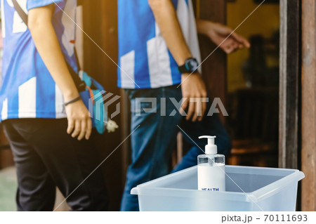 Alcohol gel bottle for hand cleaning to prevent the spreading of the Coronavirus (Covid-19)in a plastic box placed on chair to service for customers at cafe. Healthcare concept. New normal lifestyle 70111693