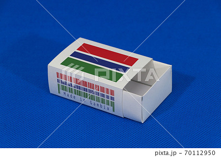 Gambia flag on white box with barcode and the color of nation flag on blue background 70112950