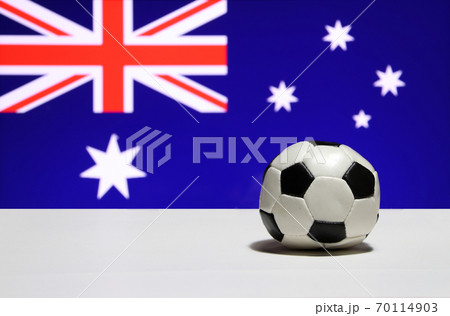 Small football on the white floor and a blue field with the Union Jack 70114903
