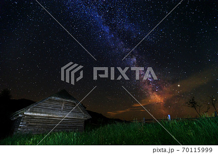 The Milky Way and old wooden hut, Transylvania, Romania, Europe 70115999