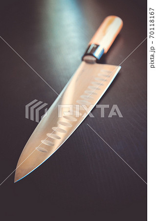 Traditional Japanese gyuto knife on black table 70118167