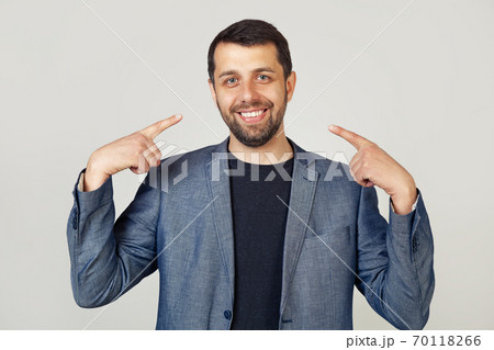Young businessman man with beard in jacket smiling confidently showing and pointing with fingers Young businessman man with beard in jacket smiling confidently showing and pointing with fingers 70118266