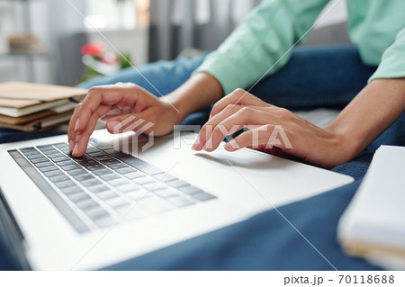 Hands of contemporary mixed-race female student pushing buttons of keypad Hands of contemporary mixed-race female student pushing buttons of keypad 70118688