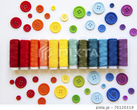 Spools of thread and buttons on the colors  of the rainbows 70120319