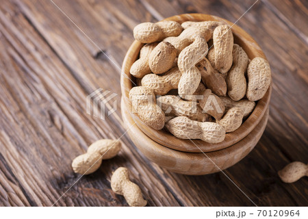 Roasted peanuts in wooden bowl Roasted peanuts in wooden bowl 70120964