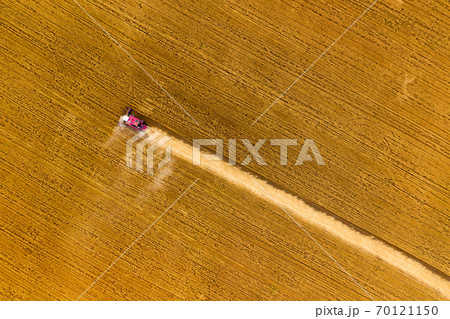 Top view of combine on harvest field 70121150