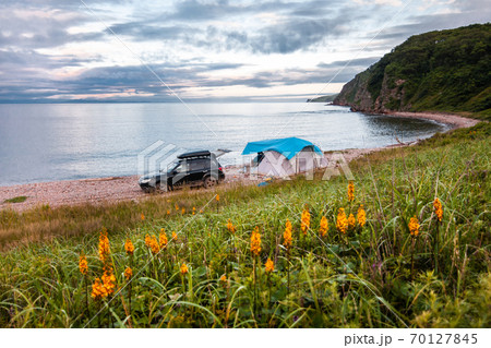 Tent camping at the sea coast. Black car near the tent Tent camping at the sea coast. Black car near the tent 70127845