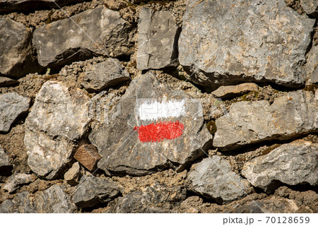 Red and White Trail Sign on a Stone Wall in Liguria Italy 70128659