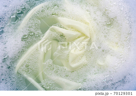 Color clothes soak in powder detergent water dissolution. Laundry concept Color clothes soak in powder detergent water dissolution. Laundry concept 70129301