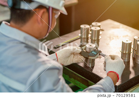 Production worker use outside micrometer inspection high metal product 70129581
