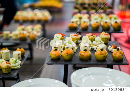 mix canapes on a tray during a coffee break mix canapes on a tray during a coffee break 70129684