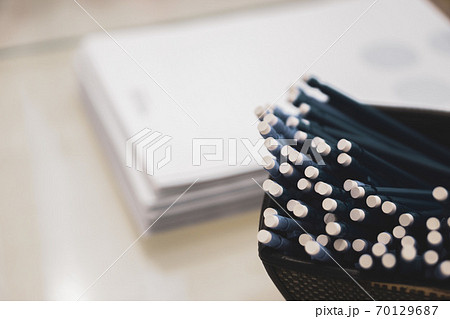 pens and pencils with an eraser on the end on the background of a stack of papers pens and pencils with an eraser on the end on the background of a stack of papers 70129687