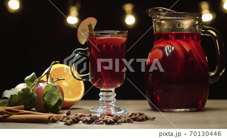Red mulled wine in a glass and jug 70130446