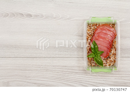 Plastic meal prep container with boiled buckwheat porridge and meat 70130747