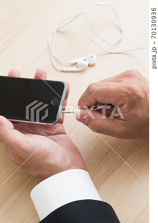 イヤホンをつける手元 70130936