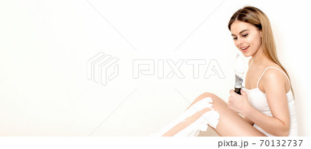 Woman shaves her legs with a knife 70132737