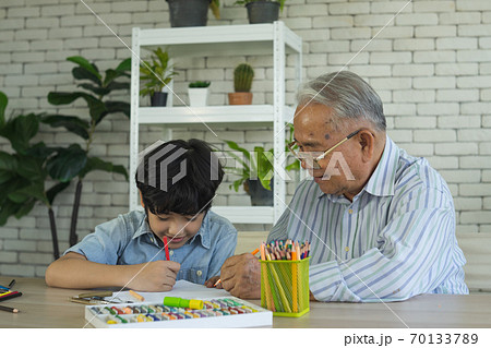 Grandson and grandfather do hobbies together. Grandson and grandfather do hobbies together. 70133789