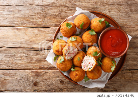 American Sauerkraut and Ham Balls served with ketchup close-up in a plate. Horizontal top view 70134246