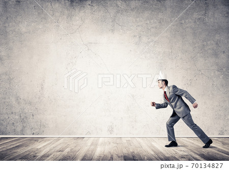 King businessman in elegant suit running in empty room King businessman in elegant suit running in empty room 70134827
