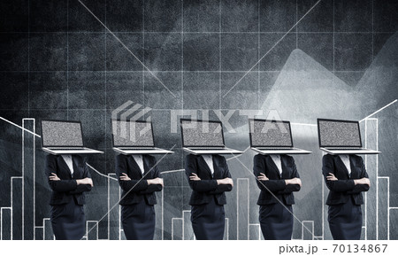 Business women with laptops instead of head. 70134867