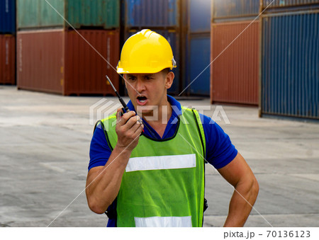industrial worker is controlling container loading in import-export business. 70136123