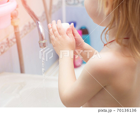 A child washes his hands with soap in the bathroom. The concept of hygiene and clean hands, infection, close-up, soundness A child washes his hands with soap in the bathroom. The concept of hygiene and clean hands, infection, close-up, soundness 70136136