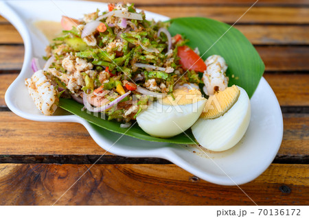 Wing Bean Sea food Salad with boiled eggs on wooden table, Thai food Wing Bean Sea food Salad with boiled eggs on wooden table, Thai food 70136172