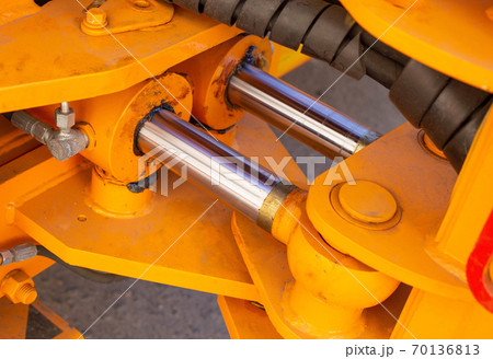 Powerful hydraulic pumps that stand in the bucket of an excavator, industry, close-up, orange 70136813