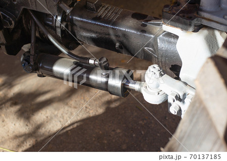Power steering pump cylinder in a truck, close-up. Relief of steering effort, mechanic Power steering pump cylinder in a truck, close-up. Relief of steering effort, mechanic 70137185