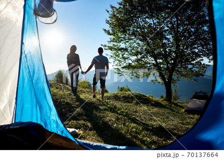 tourists man and woman in the mountains at sunny morning 70137664