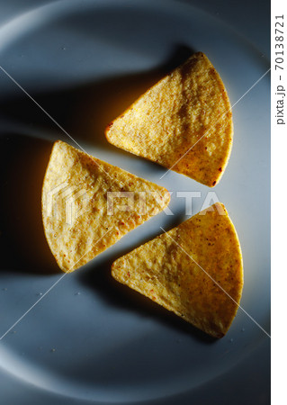 mexican nachos tortilla chips on plate, close-up view 70138721
