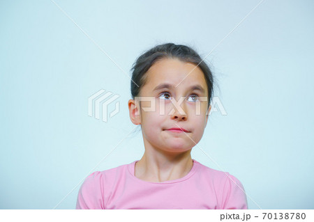 portrait of a girl who makes grimaces. 70138780