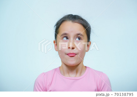 portrait of a girl who makes grimaces. 70138795