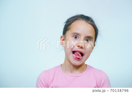 portrait of a girl who makes grimaces. 70138796