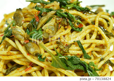 fried spicy spaghetti calm with basil leaf in chili on plate 70138824