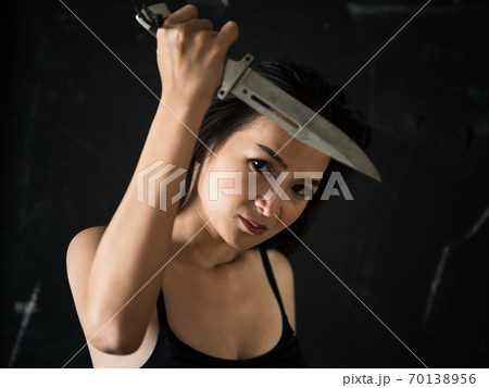 Female killer holding knife. psychopathology murder 70138956