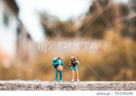 Miniature Backpacker standing on the concrete wall with natural background Miniature Backpacker standing on the concrete wall with natural background 70139109
