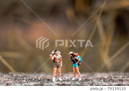 Miniature Backpacker standing on the concrete wall with natural background Miniature Backpacker standing on the concrete wall with natural background 70139110