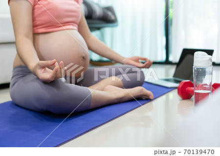 Healthy Asian pregnant woman doing yoga exercise Healthy Asian pregnant woman doing yoga exercise 70139470