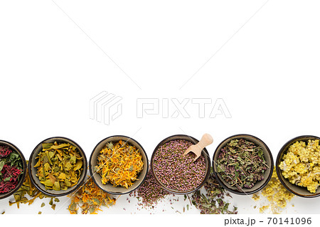 Black bowls of dry medicinal herbs on white background. Top view, flat lay. Alternative medicine. Copy space for text. 70141096