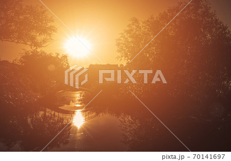 Sun over small arched bridge Sun over small arched bridge 70141697
