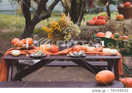 Fall themed holiday table setting arrangement for a seasonal party, banner, toned Fall themed holiday table setting arrangement for a seasonal party, banner, toned 70144032