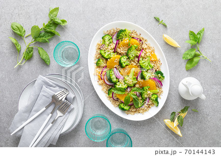 Vegan quinoa and broccoli warm salad with oranges and fresh onion, top down view Vegan quinoa and broccoli warm salad with oranges and fresh onion, top down view 70144143