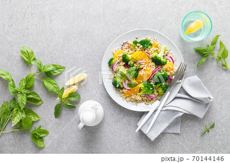 Vegan quinoa and broccoli warm salad with oranges and fresh onion, top down view Vegan quinoa and broccoli warm salad with oranges and fresh onion, top down view 70144146