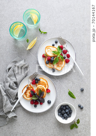 Pancakes with fresh blueberry and raspberry served for healthy vegetarian breakfast 70144167