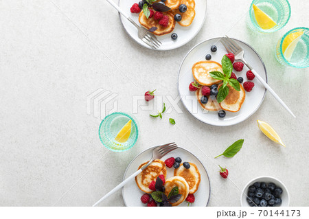 Pancakes with fresh blueberry and raspberry served for healthy vegetarian breakfast 70144173